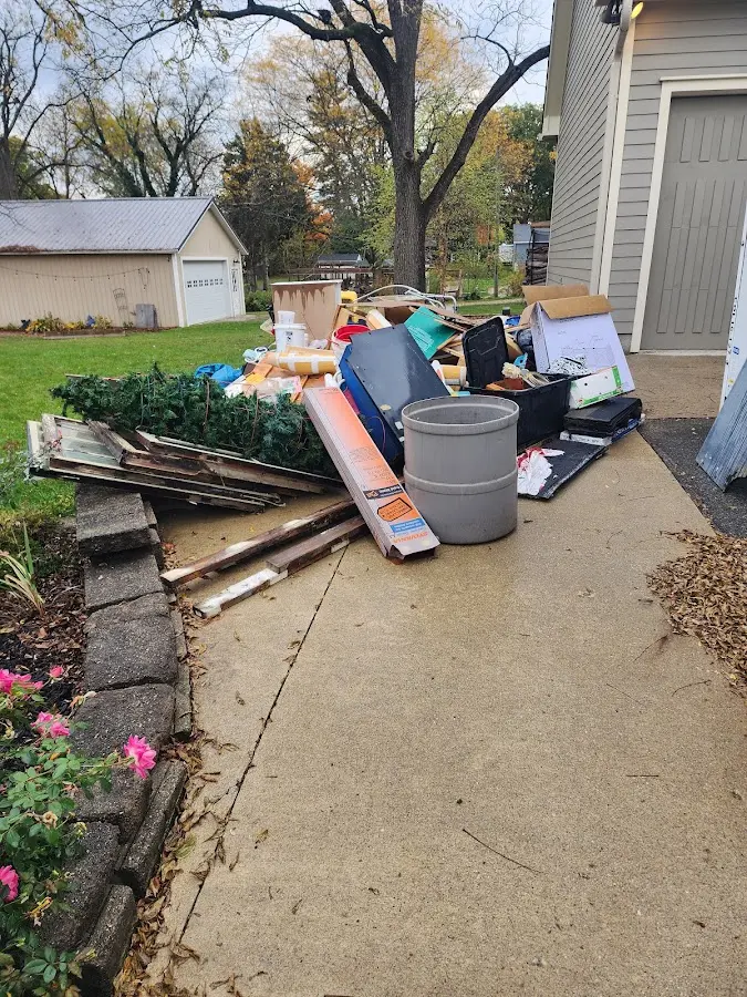 Dumpster being loaded with debris for Estate Cleanout Dumpster Rental in Poteet